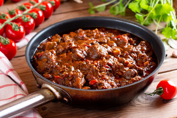 Tasty Hungarian goulash soup bograch close-up on a table and ingredients. Horizontal
