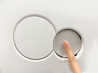 A hand flushes the toilet. Close-up of checking the toilet flush button in a store. Selecting a...