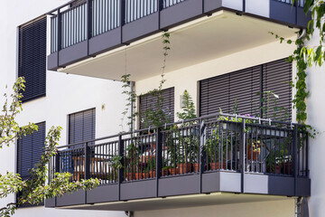 Balcony of Modern Building with Roller Blinds, External  Shutters, Flower Pots. Balcony Garden...