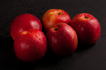 Fototapeta na wymiar Apples in water drops on dark background