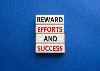 Reward Efforts and Success symbol. Concept words Reward Efforts and Success on wooden blocks. Beautiful deep blue background. Business concept. Copy space.