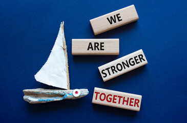 We are stronger together symbol. Wooden blocks with words We are stronger together. Beautiful deep...