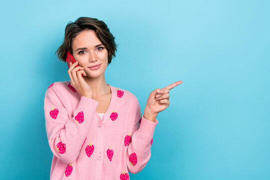 Photo of glamour brown hair girl wear trendy clothes speak phone arm presenting empty space 5g connection isolated blue color background