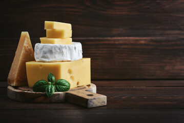 Different types of cheese: Camembert, Maasdam, Parmesan