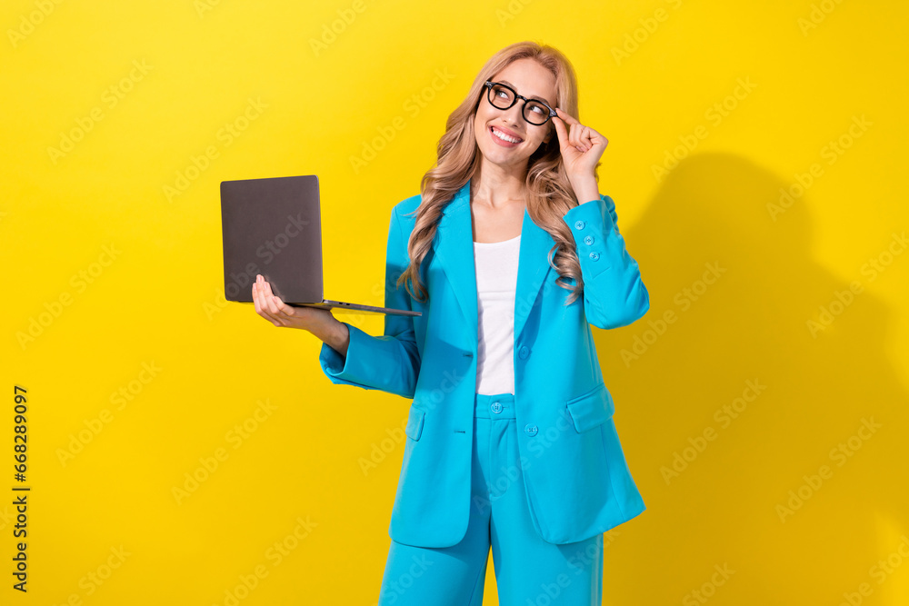 Poster photo of gorgeous minded creative girl hold netbook arm touch eyewear look empty space isolated on y