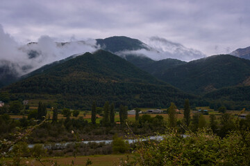 Rural landscape with clouds between mountains