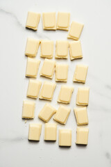 White chocolate bar on white marble background. 