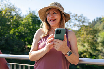 Adult woman smiling using smart phone
