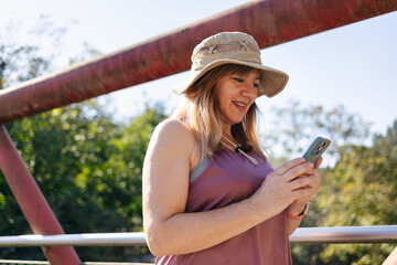 Adult woman smiling looking at smart phone