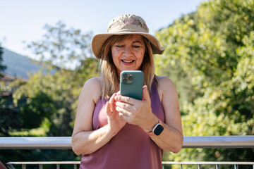 Adult woman smiling looking at smart phone