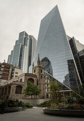 St Andrew Undershaft Church in front of modern skyscraper buildings background. Architectural view of old and new buildings in contrasting classical and modern designs, Space for text, Selective focus