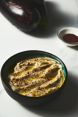 Mutabal or Moutabal - Middle Eastern dip made from roasted eggplants with tahini, garlic and lemon juice. It's creamy, smoky, and tangy.