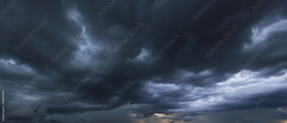 Poster the dark sky with heavy clouds converging and a violent storm before the rain.bad or moody weather s