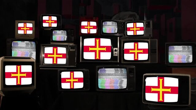 Flag of Guernsey, the Second Largest Island in the Channel Islands, and Vintage Televisions. 4K.