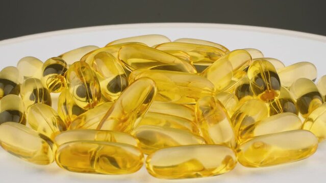 Medicines and nutritional supplements of vitamin d. Fish oil in omega fatty acids. Pills and tablets for health maintenance and prevention and treatment. Vitamins in capsules spinning on a plate