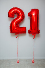red foil number 21 balloons on white background