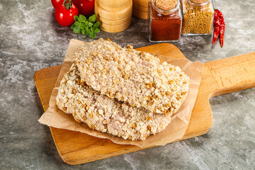 Breaded raw breaded meat schnitzel