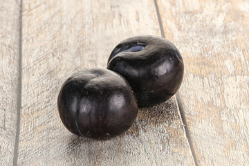 Two ripe sweet black plums