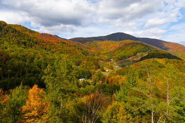 Looking down into a valley with vivid fall colors blazing