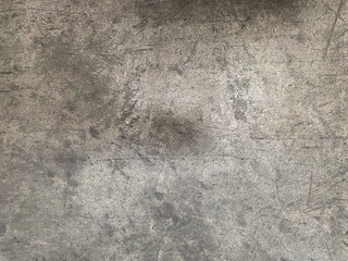 Seamless background photo of light grey scratched concrete.