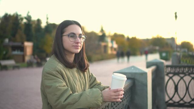Young woman with a glass of coffee in her hand. 