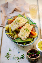 Poashed cod with vegetables and aioli .top veiw