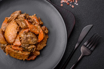 Delicious vegetable stew of potatoes, beef meat, mushrooms, carrots, salt, spices and herbs