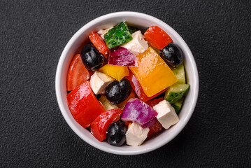 Delicious juicy Greek salad with feta cheese, olives, cucumber and tomatoes