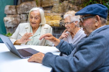 Senior people using laptop in a nursing home