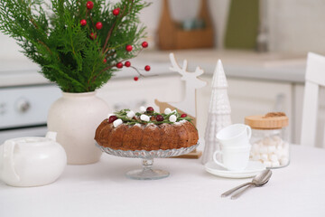 Christmas home interior in white kitchen Christmas chocolate bundt cake with fresh berries and rosemary. Winter baking. christmas trees. High quality photo