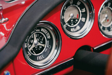Vintage dashboard with various gauges on a retro car