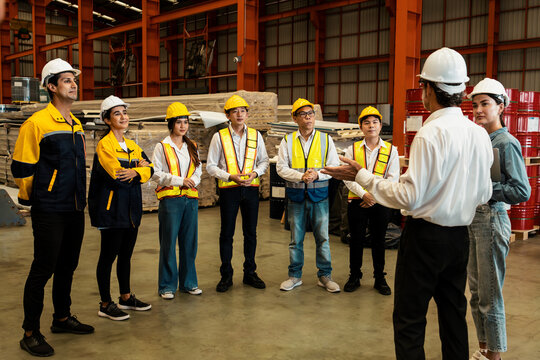 Collective factory worker and engineer gather for meeting with factory executive or manager, discussing plan and industry training program on-site work heavy industrial steel workshop. Exemplifying
