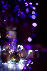 Purple and gold christmas baubles, shiny glittery decorations, magical lights.