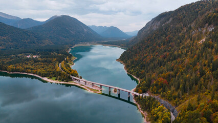 Aerial drone view of Faller-Klamm-Brucke bridge over Silvenstein lake, Karwendel mountain range Alps, Upper Bavaria, Germany in auttumn - obrazy, fototapety, plakaty