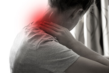 A girl holds her hands behind her neck at home, sore neck