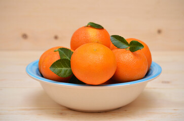 ripe tangerines in a bowl close-up