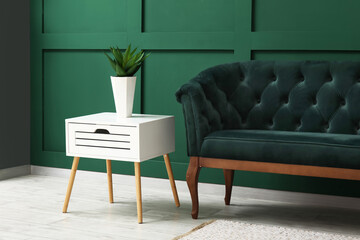 Interior of living room with green sofa and table