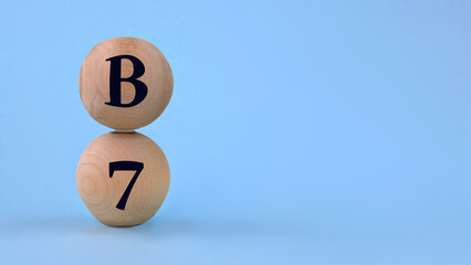 Vitamin B7 on wooden balls on a blue background