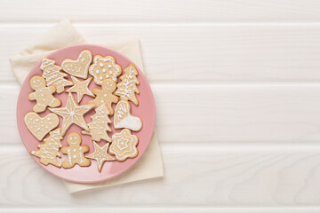 Cute homemade Christmas cookies with decor on wooden background,top view
