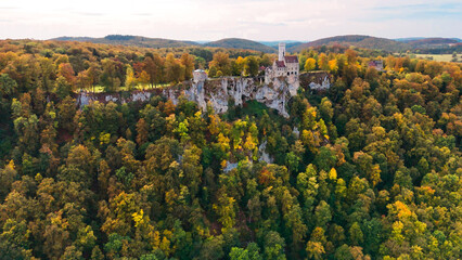 Aerial drone view medieval Lichtenstein castle on mountain, autumn Baden-Wurttemberg, Germany.