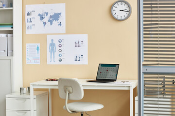 Background image of doctors workplace with desk and laptop in medical clinic, copy space