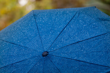 Raindrops on a blue umbrella 