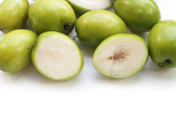 Green jujube fruits on white background.