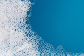 Detergent foam bubble on water. Blue background, Soap sud