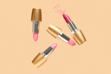 Flying lipsticks on color background