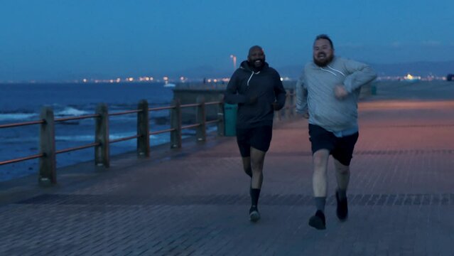 Plus size fitness, ocean and men running for weight loss goals, health diet and training for cardio marathon race. Speed exercise, diversity and fast overweight people, black man or runner workout