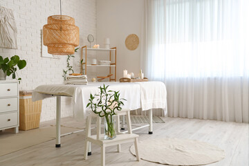 Interior of spa salon with couch and burning candles
