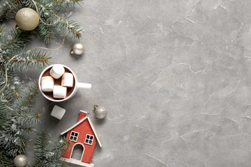  Cup of tasty cocoa with marshmallows and Christmas decor on grey background © Pixel-Shot