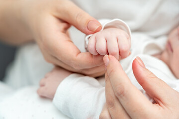 Obraz na płótnie Canvas Mother's finger embraced by newborn's gentle grip unveils emotions. Concept of profound maternal love