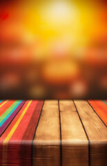 Wooden table with painted colors, blurred background of lights and colors. Space for text, advertising, brand or product - obrazy, fototapety, plakaty